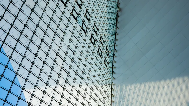 Geometric glass facade in Shanghai, an editorial image for research on approving investment managers.