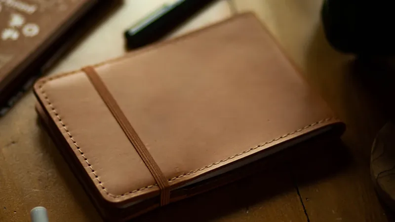 A leather notebook and pen on a table, illustrating the annual PPLI review checklist.